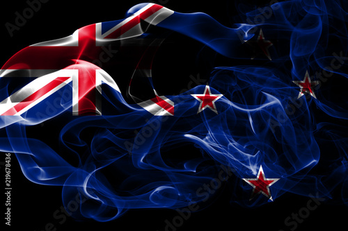 National flag of New Zealand made from colored smoke isolated on black background. Abstract silky wave background.