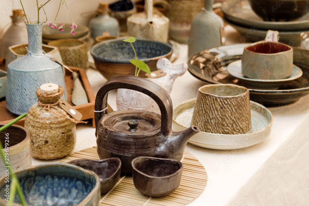 Handmade pottery dishes on shop window of a street market. Chiang Mai, Thailand.