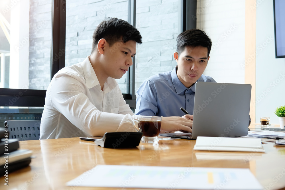 Business partner talking and consult with laptop computer and paper document. Business partner talking and consult with laptop computer and paper document.