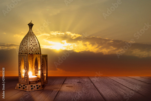 festive oriental lantern on wooden planks in sunset for ramadan celebration greeting card