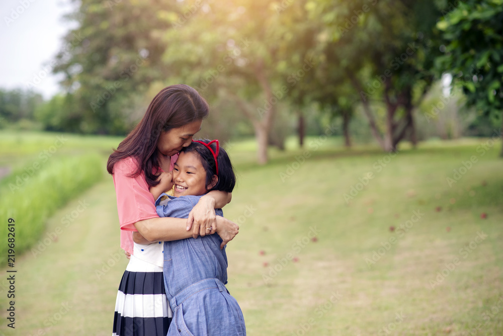 Asian mother and little cute child playing together outdoors (rice field).Happy family in mother's day concept,I Love you best mom.Mum and adorable little daughter greeting ,proud and hug together. Asian mother and little cute child playing together outdoors (rice field).Happy family in mother's day concept,I Love you best mom.Mum and adorable little daughter greeting ,proud and hug together.