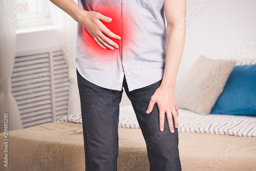 Attack of appendicitis, man with abdominal pain suffering at home