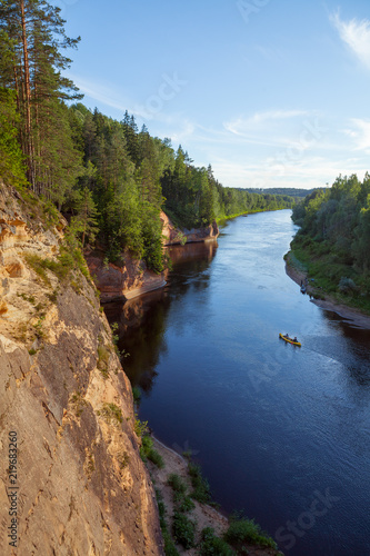 Peaceful landscape with Gauja river and red sandstone (Erglu klint) steep rocks in Gauja National Park in Valmiera area
