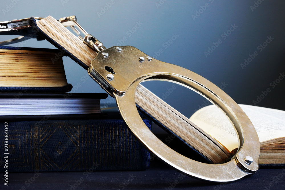 Obraz premium Legal system and Justice concept. Handcuffs and open book.