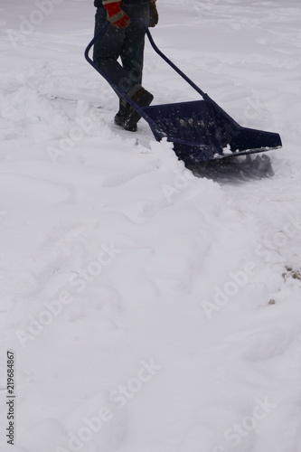 A man is shoveling snow. A lot of snow.