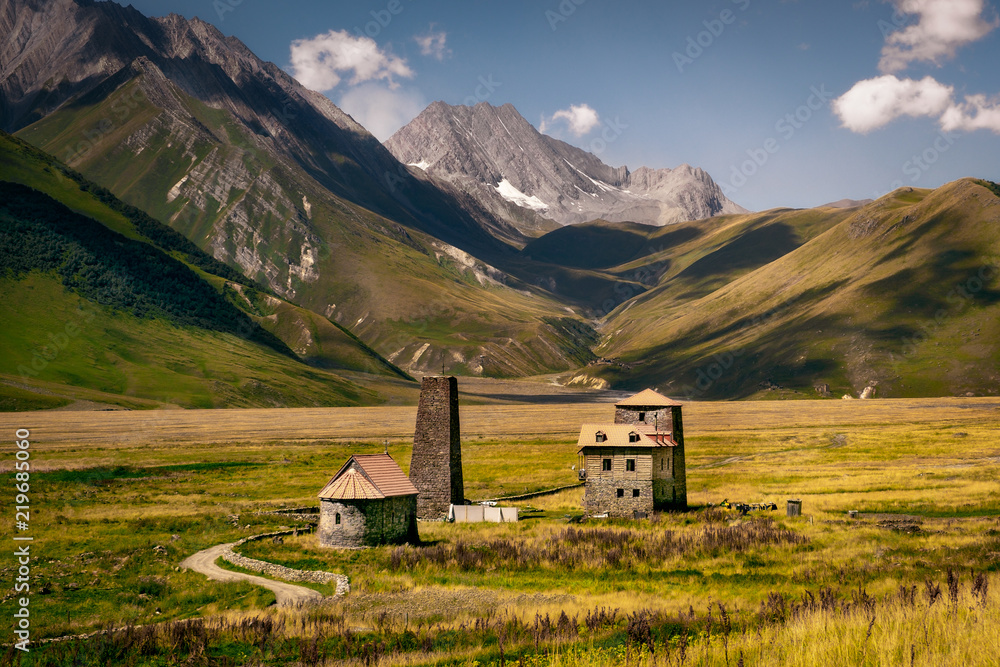 Landscape view of Caucasus mountains and stone houses and tower, Country of Georgia