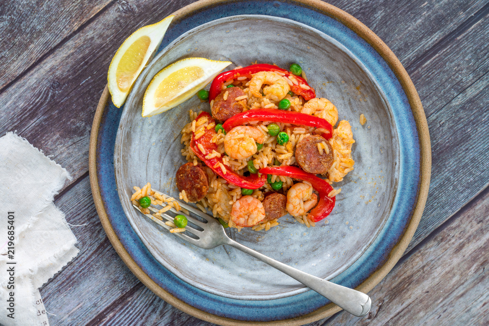 Spanish paella with prawns, chicken, chorizo and red pepper - top view Spanish paella with prawns, chicken, chorizo and red pepper - top view