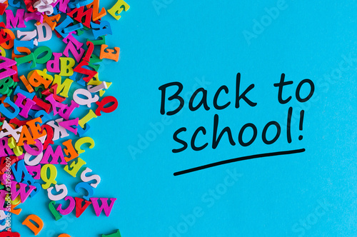 Back to school - Message at blue background with many little color letters. Education concept, 1 september time