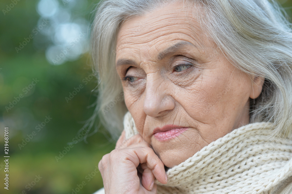 Portrait of a sad senior woman in autumn park Portrait of a sad senior woman in autumn park