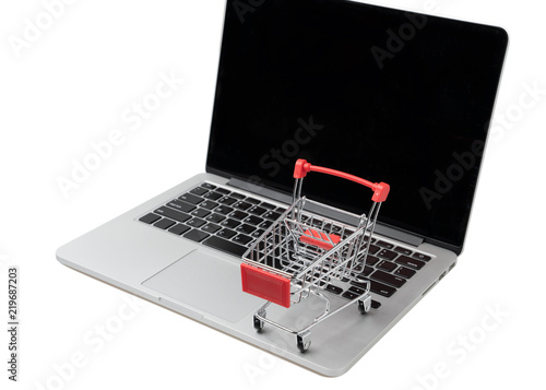 Shopping cart on a laptop keyboard. Ideas about e-commerce, E-commerce or electronic commerce is a transaction of buying or selling goods or services online over the internet.