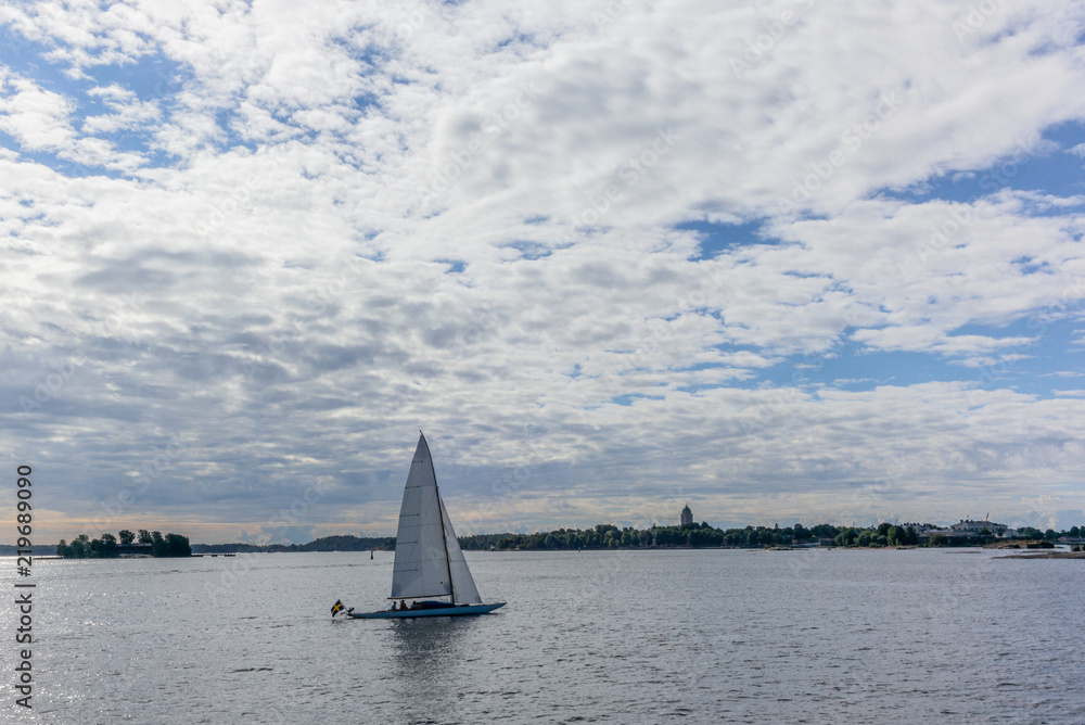 A lonely sailing boat with the skyline of Helsinki in the background- 2
