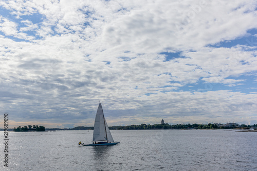 A lonely sailing boat with the skyline of Helsinki in the background- 2