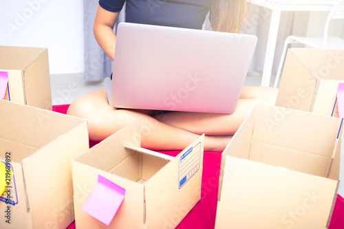 success start up business entrepreneur or freelance woman concept , typing computer with box, online marketing packaging box and delivery © pascalkphoto
