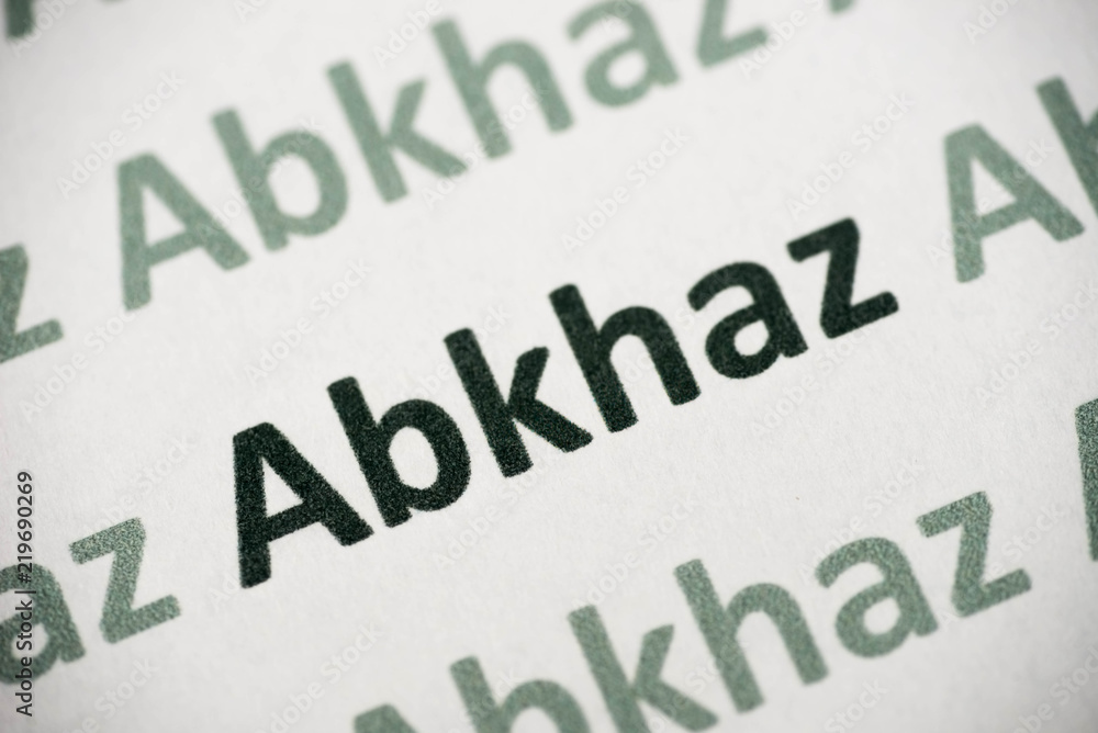 word Abkhaz  language printed on paper macro