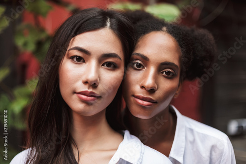 Portrait of beautiful girls in white shirts dreamily looking in camera