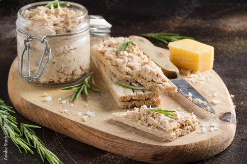 Tuna pate with egg, cheese in jar and crispy bread. Fish rillette, healthy snack, diet food