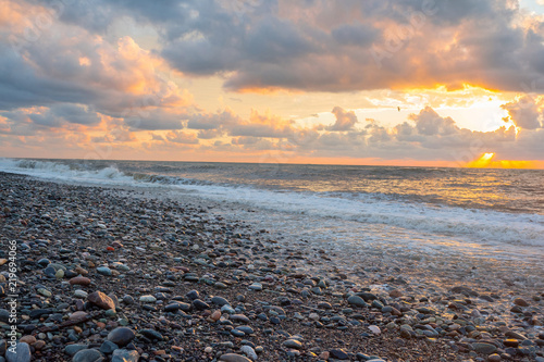 A sunset during a storm. A beautiful sea beach.