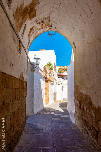 Beautiful Greek narrow street in historic Lindos on Rhodes island. Dodecanese, Greece.