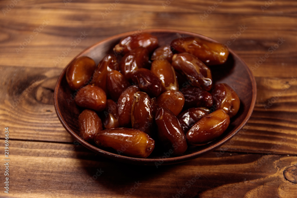 Dried dates fruit on wooden table Dried dates fruit on wooden table