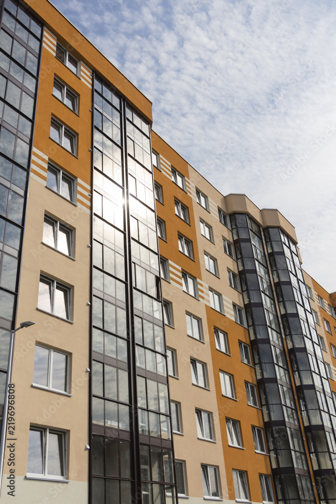 Modern apartment building in sunny day against blue sky. Modern apartment building in sunny day against blue sky.