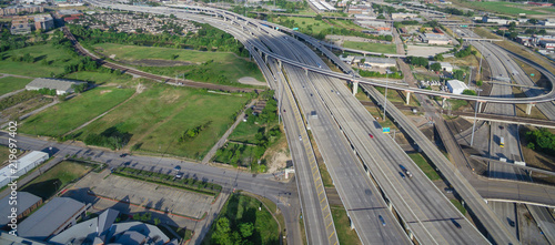 Panorama aerial view Houston suburbs subdivision from northeast side of downtown. Top view interstate I69 highway intersection, stack interchange with elevated road junction overpass photo