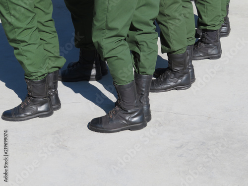Feet of soldiers in military uniform and boots. Concept for service in the army and armed forces