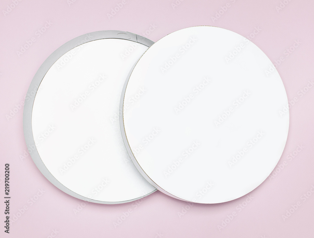 Round white cardboard blank box top view flat lay. Mock up on pink background. Packaging design, an empty box for shopping. Round white cardboard blank box top view flat lay. Mock up on pink background. Packaging design, an empty box for shopping.