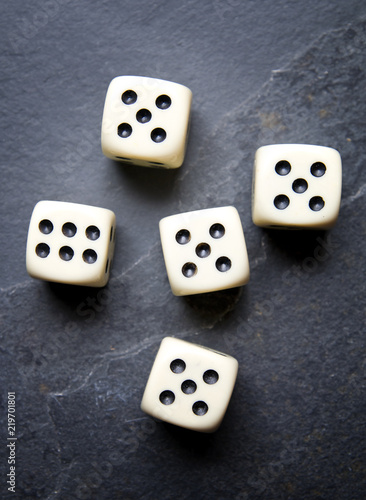 Dice for game on a black background. Four identical bones.