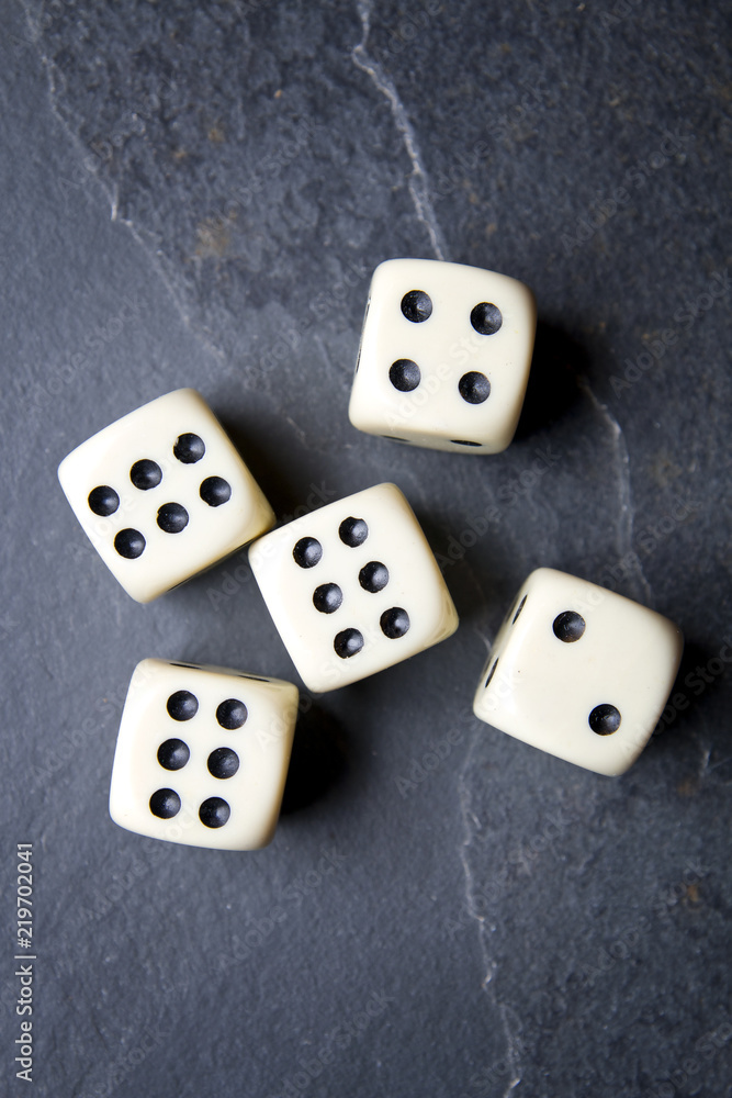 Dice for game on a black background. Three identical bones. Dice for game on a black background. Three identical bones.