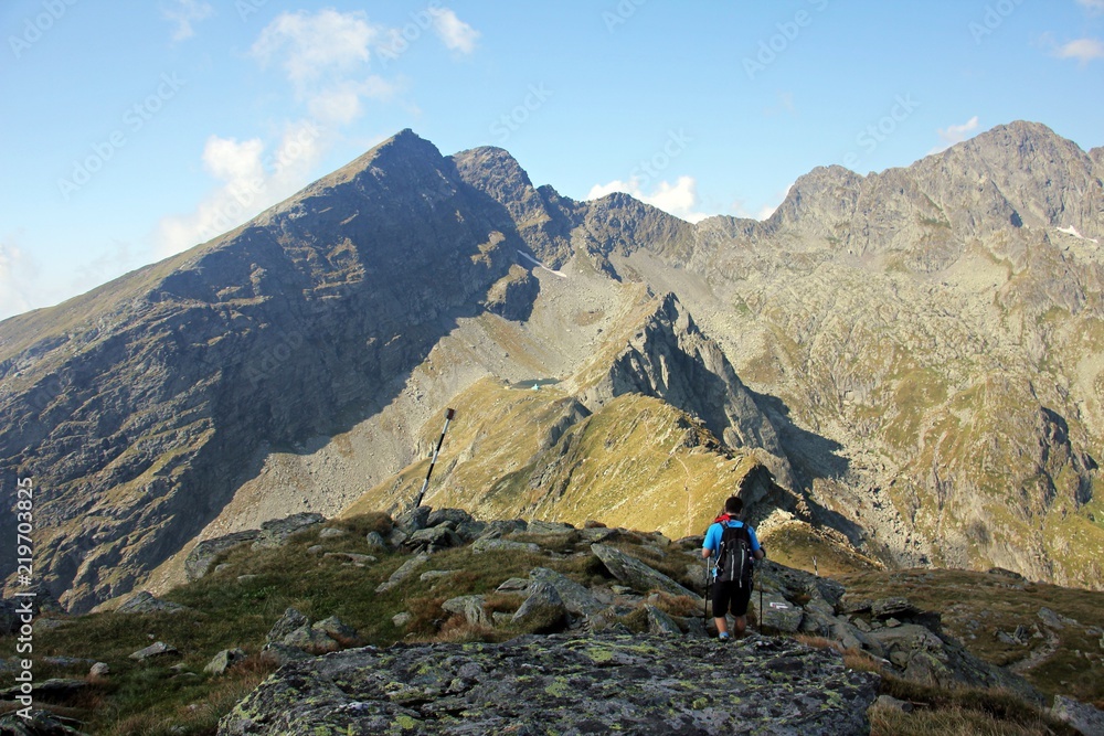 Amazing mountains during summer with hiker on the trail