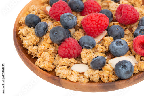 Cup of gaanola with almonds and fresh berries for breakfast