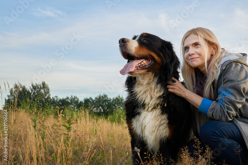 Fotografie portrait of a big dog and a girl in nature