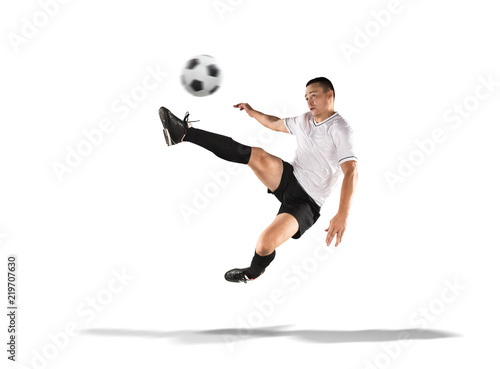 soccer player kicking the ball in the air isolated on white