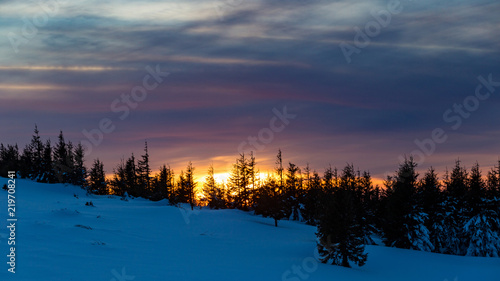 Astonishing sunset colours during a cold winter day in the mountains in Romania