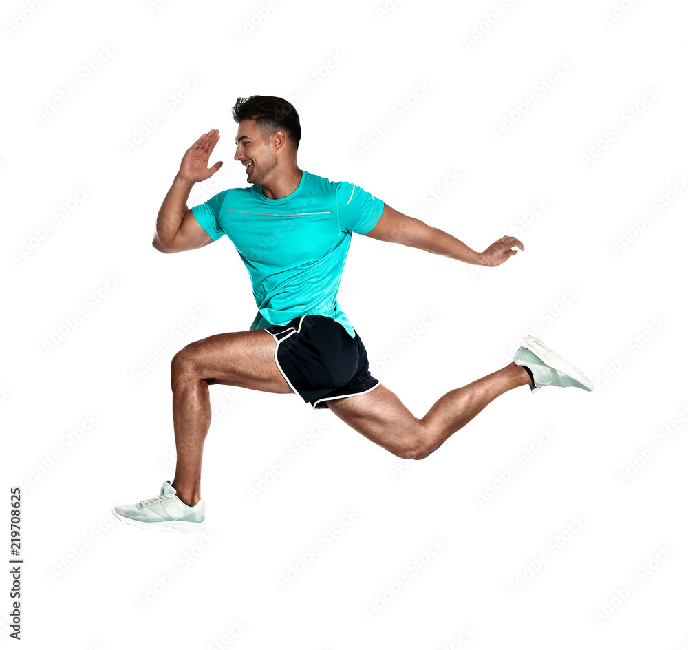 Handsome young man running on white background