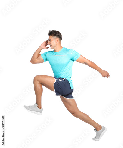 Handsome young man running on white background