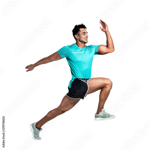 Handsome young man running on white background