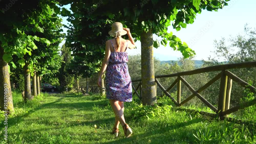 Montepulciano, Tuscany, Italy. Girl is walking in the city park on sunset Montepulciano, Tuscany, Italy. Girl is walking in the city park on sunset