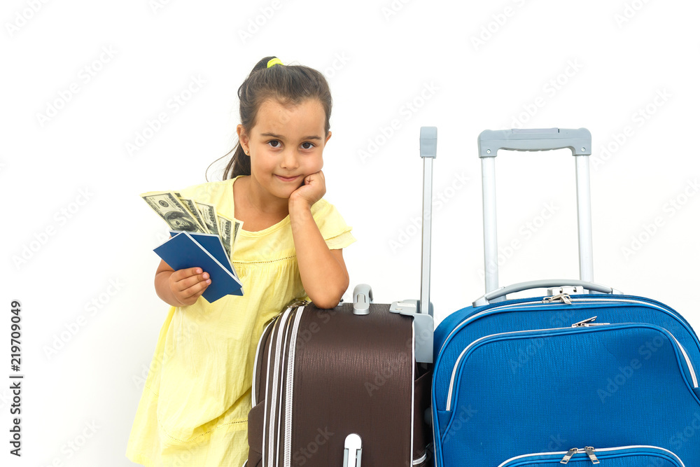 Happy child traveler showing passport with baggage isolated on white background, travel and vacation concept Happy child traveler showing passport with baggage isolated on white background, travel and vacation concept