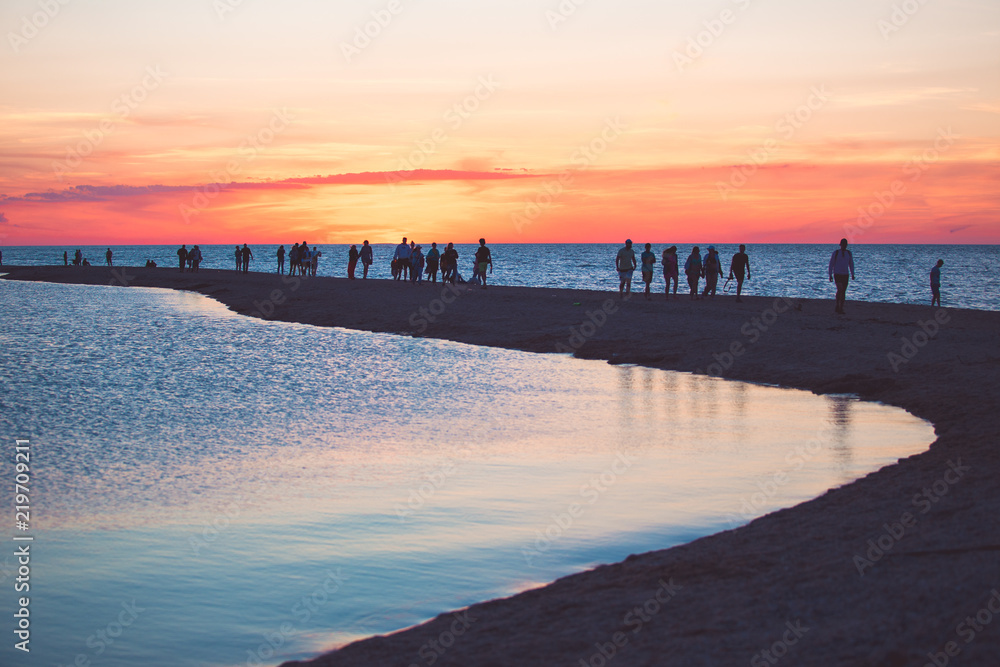 Beautiful seascape with people watching the sunset over the sea