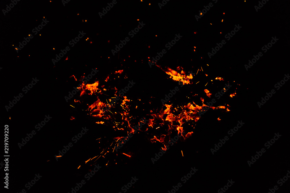 Flame of fire with sparks on a black background Flame of fire with sparks on a black background
