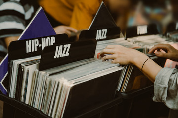 Fotobehang Muziekwinkel Vrouw bekijkt vinylplaten in winkel  © Ivan Kurmyshov