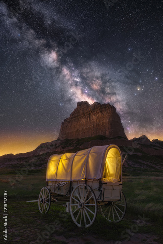 Night sky over old covered wagon along the historical Oregon Trail in Nebraska photo