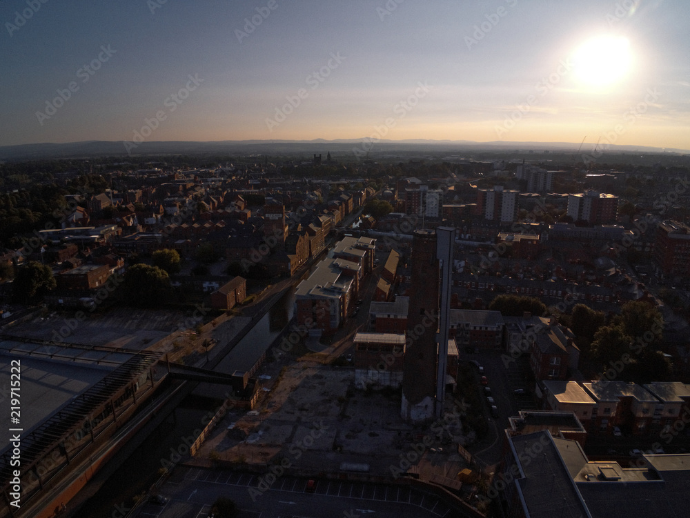 Aerial view, drone silhouette of Chester city during sunset sun close to canal, old shot tower and steam mill area