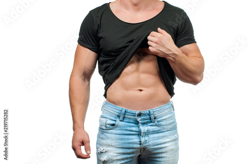 Diet  Muscular man with perfect body. Fitness man showing six pack