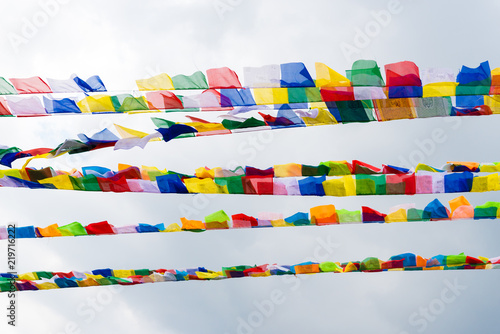 Traditional buddhist prayer flags over blue sky background