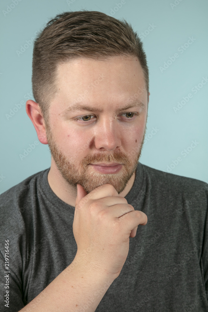 Bearded casual man with hand on his chin Bearded casual man with hand on his chin
