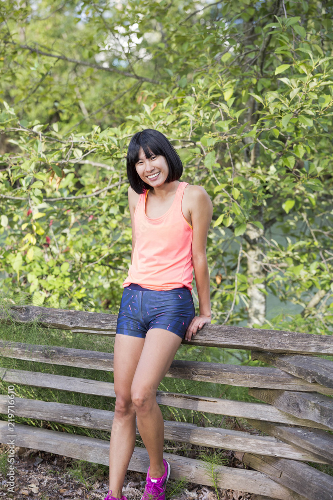 Naklejka premium Asian Athlete Relaxing in the Park
