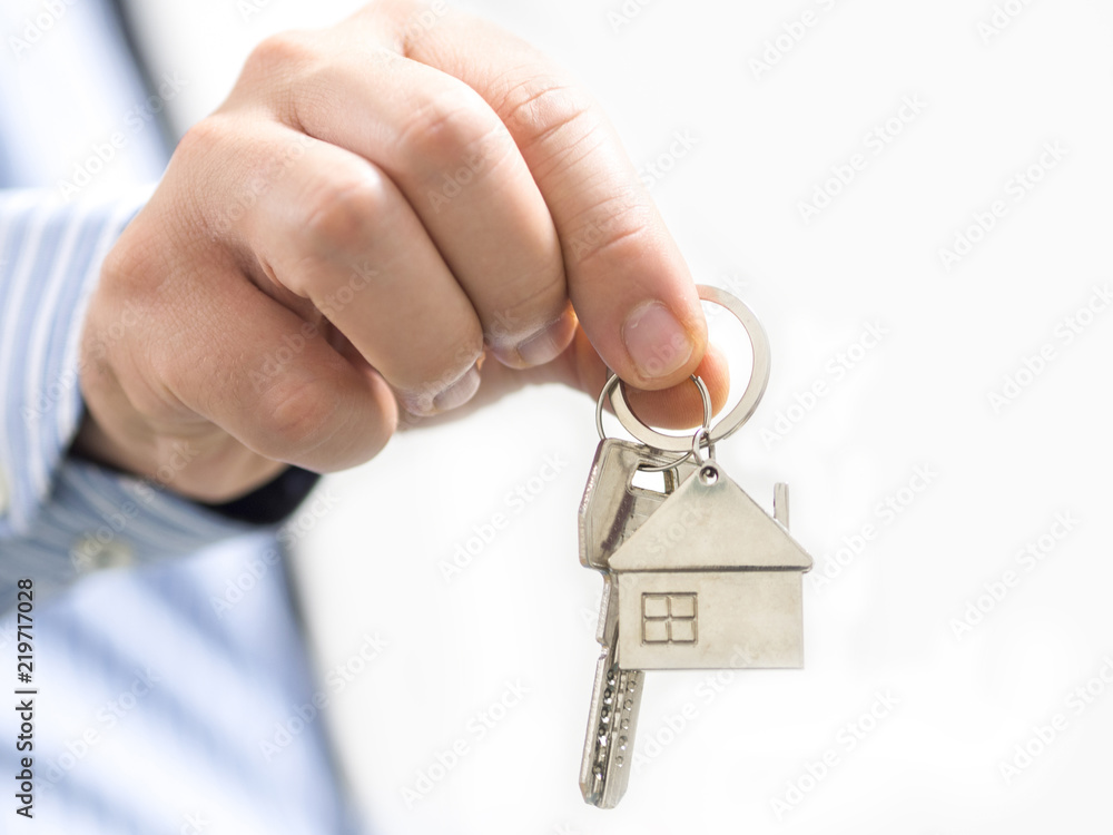 man holding a home key in his hand