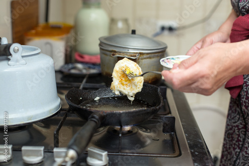 fry an egg on a gas stove © donikz